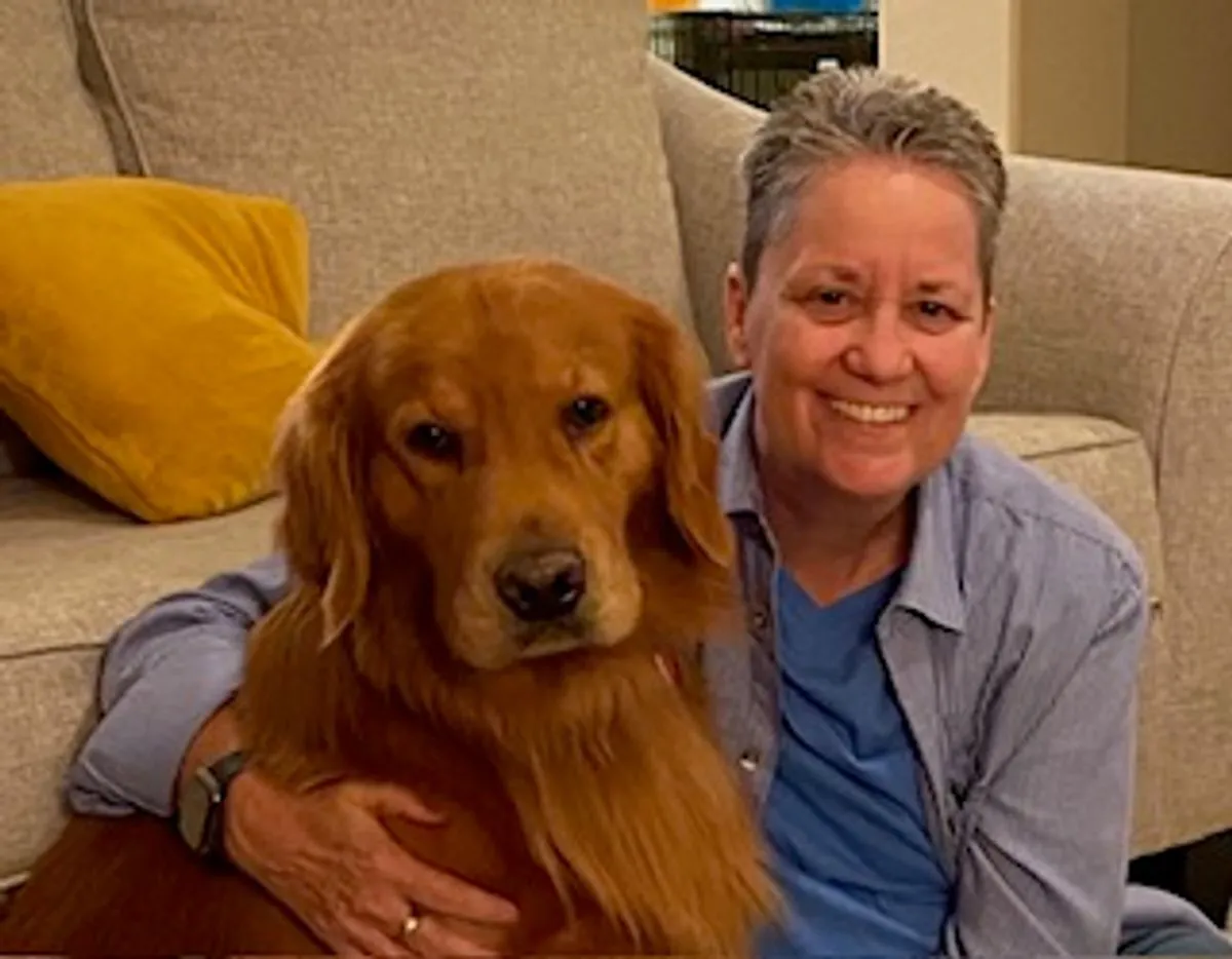 Alex Warren sitting beside Wrigley, a red-gold Golden Retriever
